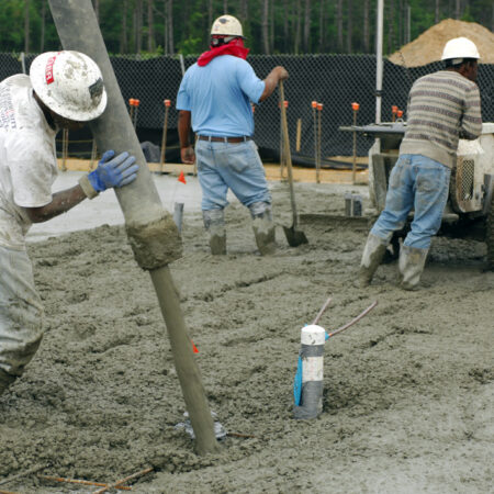 MOODY AIR FORCE BASE, Ga. -- A contractor pours concrete here, April 10. Contractors have been working since 0100 this morning on a two bay fuel cell hanger floor that will take over twelve hours and more than ninety concrete trucks to complete. (U.S. Air Force photo/Staff Sgt. Joshua T. Jasper)